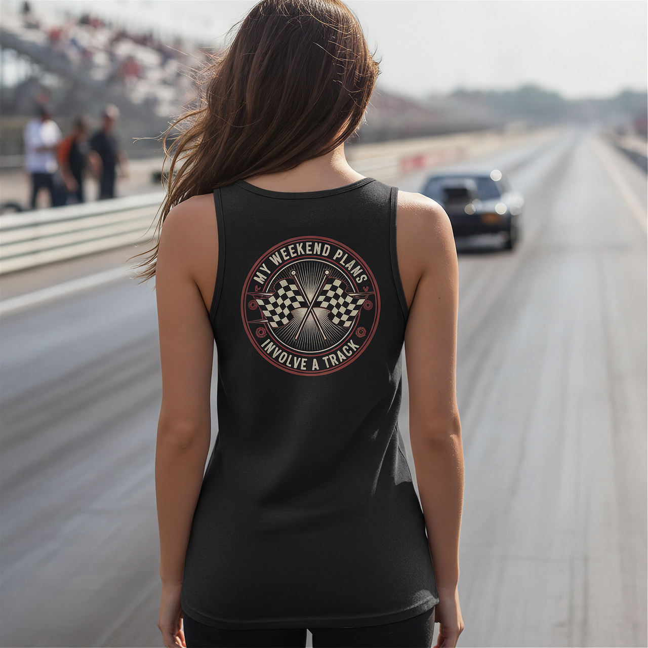 Woman wearing a black tank top with a graphic design on a race track