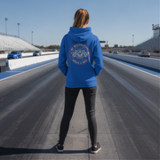 Man wearing a blue hoodie with a logo on a race track