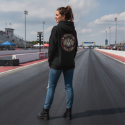 Woman wearing a black hoodie with a logo on a race track