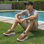 Man sitting by a pool wearing orange and black checkered shoes