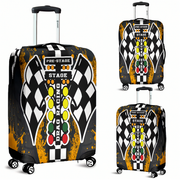 Three views of a hard-shell suitcase with a drag racing themed print. The design features a black and white checkered flag, a vertical row of yellow, green, and red race lights, and distressed orange paint splatters on a black background.
