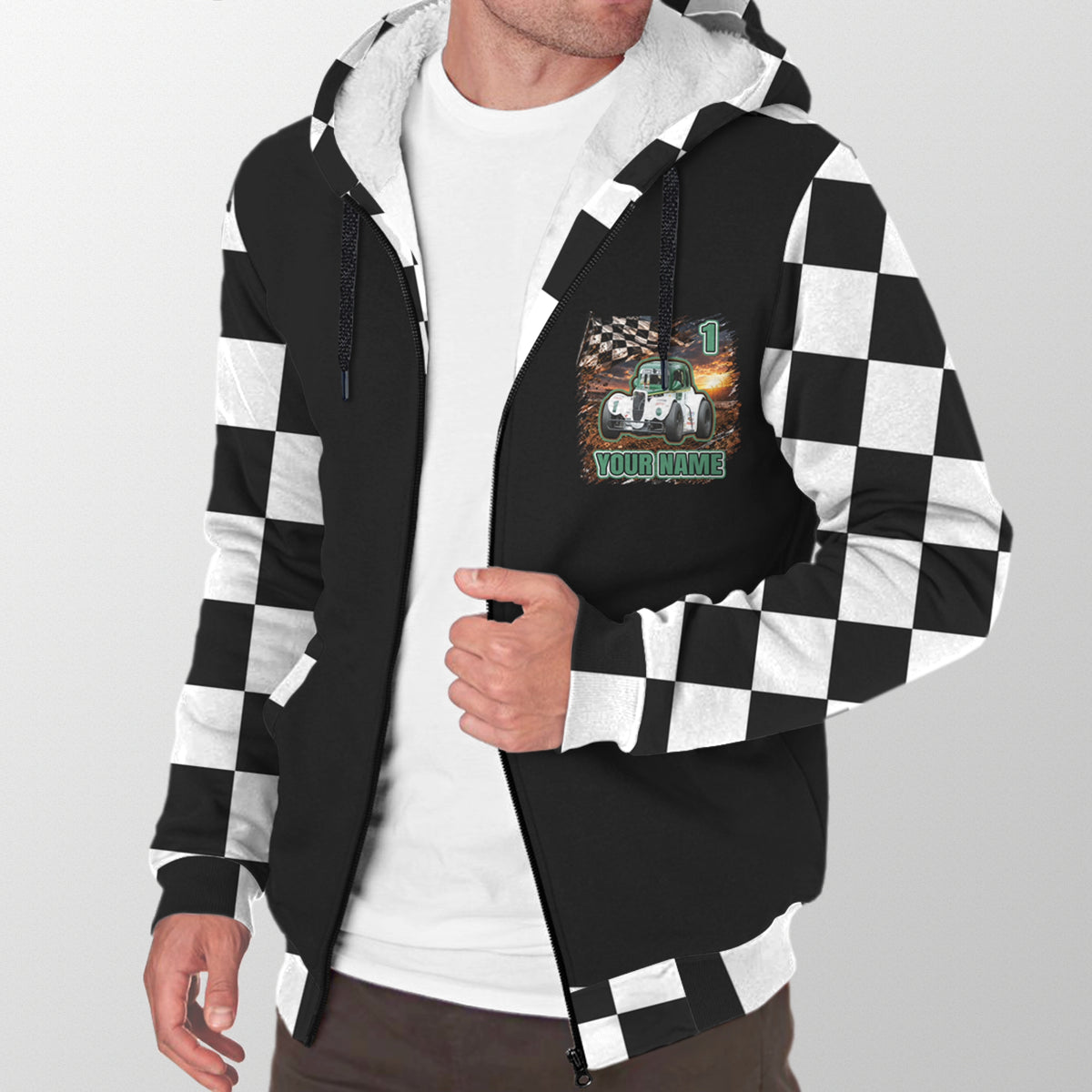 Man modeling a black Legends car sherpa jacket with personalized chest artwork, checkered sleeves, and white lining.