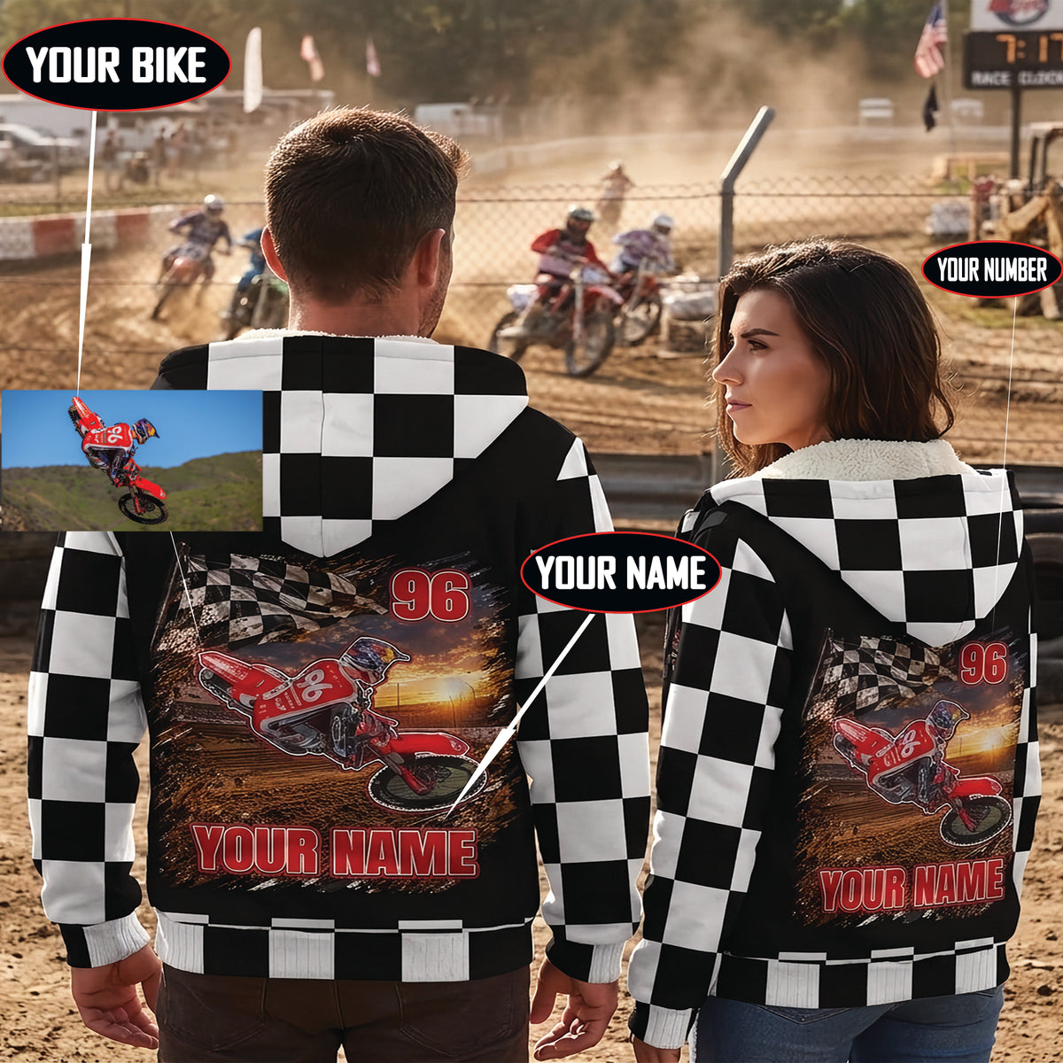 Couple wearing personalized dirt bike sherpa jackets at a motocross track, showing matching rider artwork, number 96, and name designs.