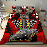 A racing-themed bedding set featuring a duvet cover and two pillowcases with a black and red drag racing design, including a car graphic, checkered flags, and starting lights, shown on a bed in a bedroom.