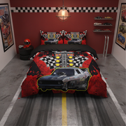 A racing-themed bedding set displayed on a bed in a styled bedroom. The set includes a duvet cover and matching pillowcases featuring a black race car, checkered flags, and red splatter graphics.