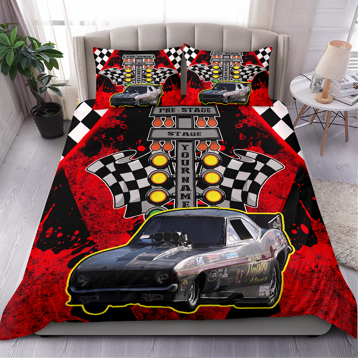 A racing-themed bedding set featuring a duvet cover and two pillowcases with a black and red design, checkered flags, speedometers, a race car graphic, and the words 'The Stage' and 'Your Name'. The set is displayed on a bed in a styled bedroom setting.