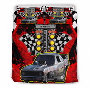 A racing-themed bedding set featuring a duvet cover and two pillowcases with a bold graphic print. The design includes a black and gray race car, checkered flags, yellow traffic lights, and a central sign reading 'STAGE YOUR NAME'.