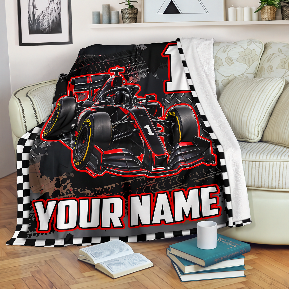 A custom fleece throw blanket featuring a black and red Formula 1 race car design, a large number 1, and 'YOUR NAME' text, draped over a light beige sofa in a living room setting.