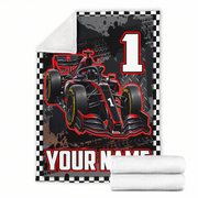 A customizable fleece blanket featuring a red and black Formula 1 race car, a large white number 1, and 'YOUR NAME' text, shown with a folded white sherpa lining and two rolled white towels on a white background.
