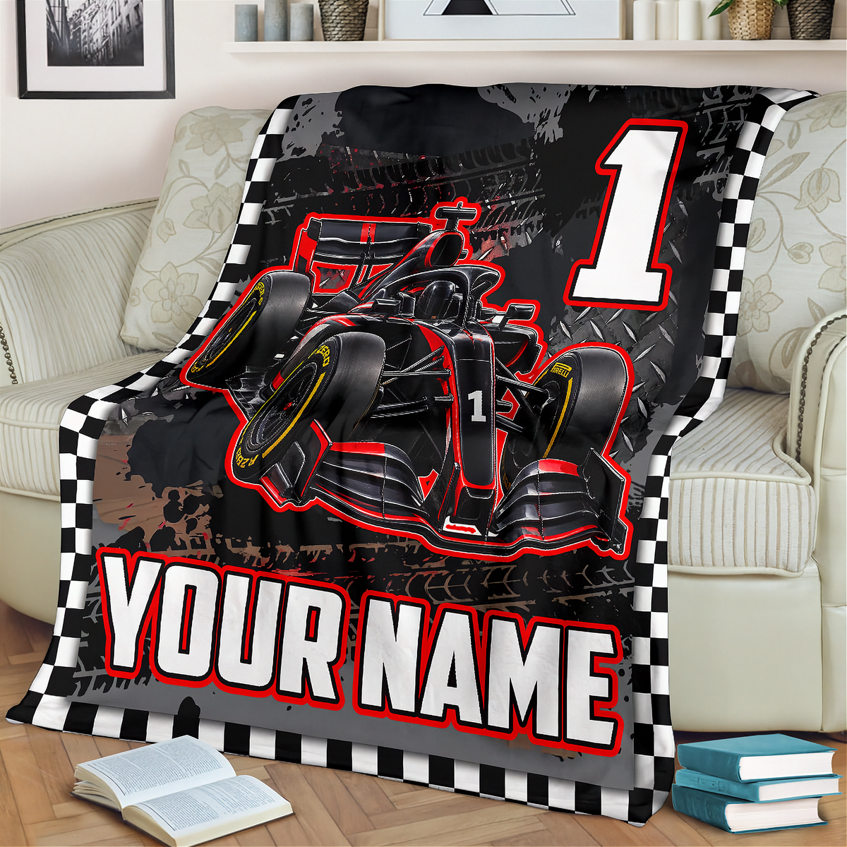 A custom racing-themed blanket draped over a light beige sofa in a living room setting. The blanket features a black and red Formula 1 style race car graphic, a large white number '1', a black and white checkered border, and customizable text reading 'YOUR NAME'.
