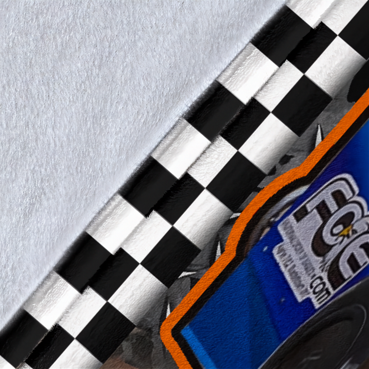 A close-up of a checkered black and white racing stripe pattern, with part of a blue and orange vehicle or graphic visible in the lower right corner.