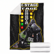 A fleece blanket featuring a drag racing graphic with a motorcycle racer, tire tread background, and illuminated speed light columns, shown with a white sherpa reverse side and two folded white ends on a white background.