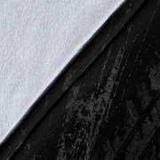 A close-up of a black textured surface with a diagonal split showing a white textured side.
