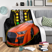 blanket featuring an orange race car and the words 'PRE-STAGE DRAG RACING' with yellow and green lights.