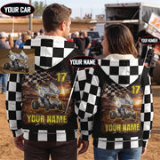 Couple wearing matching personalized sprint car sherpa jackets at a dirt track, showing checkered backs with car, name, and number.
