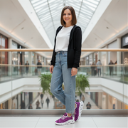 Woman standing in a modern mall with glass walls and high ceilings and pink checkered shoes