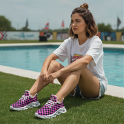 Woman sitting by a pool wearing checkered sneakers