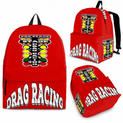 An adult man and an 8 to 12 year old child walking side by side down a drag strip lane toward the staging lights, both wearing identical custom red drag racing track backpacks viewed from behind.