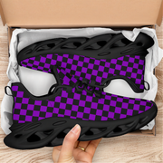 Black and purple checkered sneakers in an open box on a wooden surface