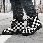 Black and white checkered boots worn with dark jeans on a snowy street.