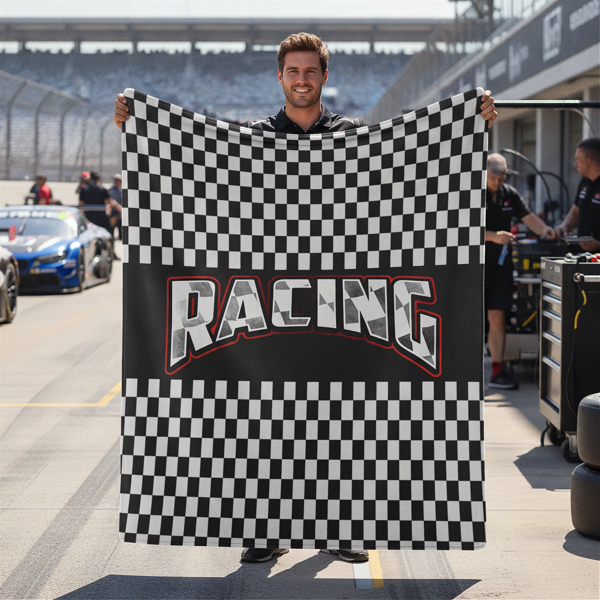 Man holding a checkered racing flag at a race track
