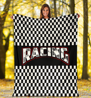 Woman holding a checkered racing flag with 'Racing' text in a forest setting