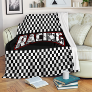 Checkered racing blanket draped over a couch in a living room.