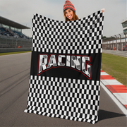 Person holding a checkered racing blanket on a race track