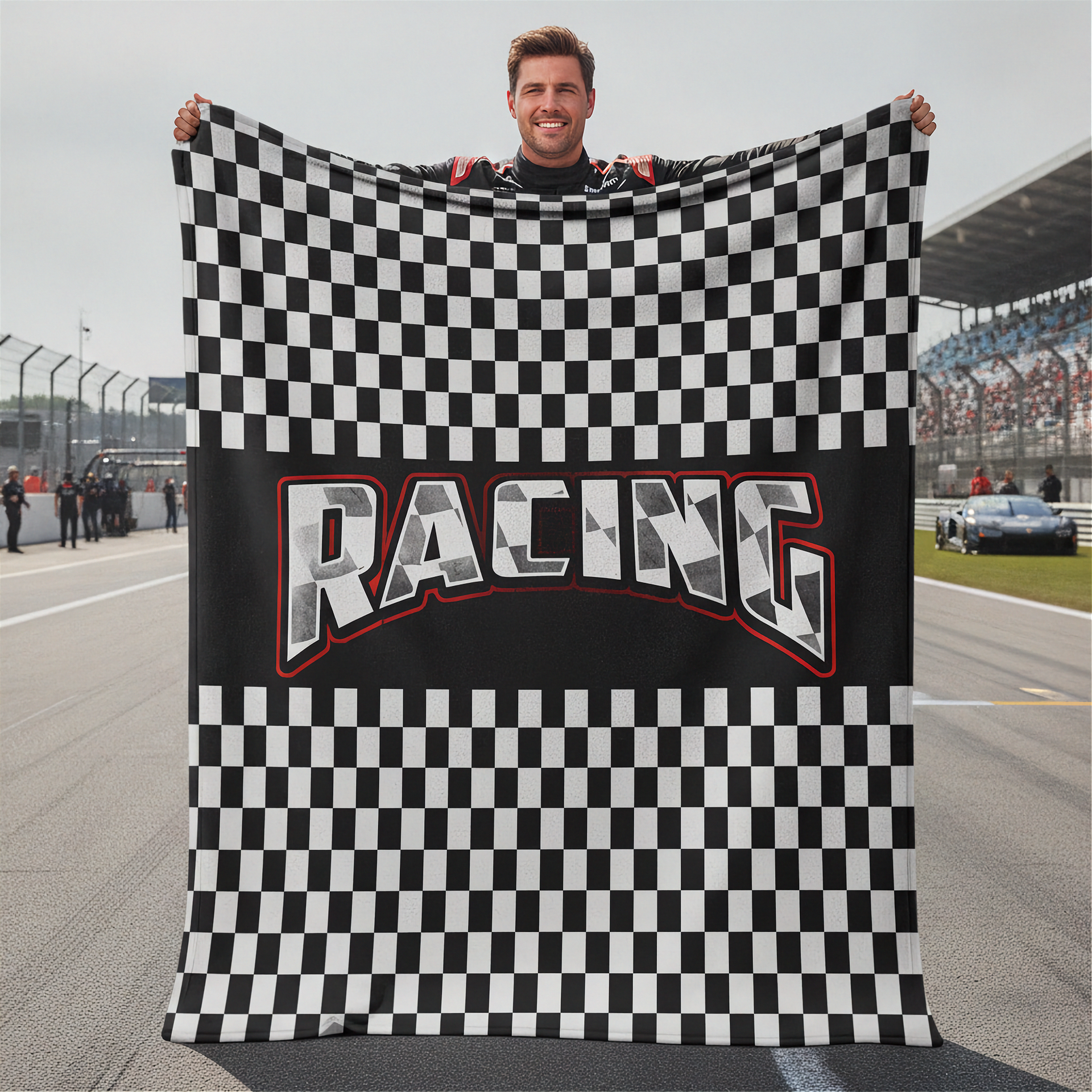 Person holding a checkered racing flag with 'Racing' text on a race track.