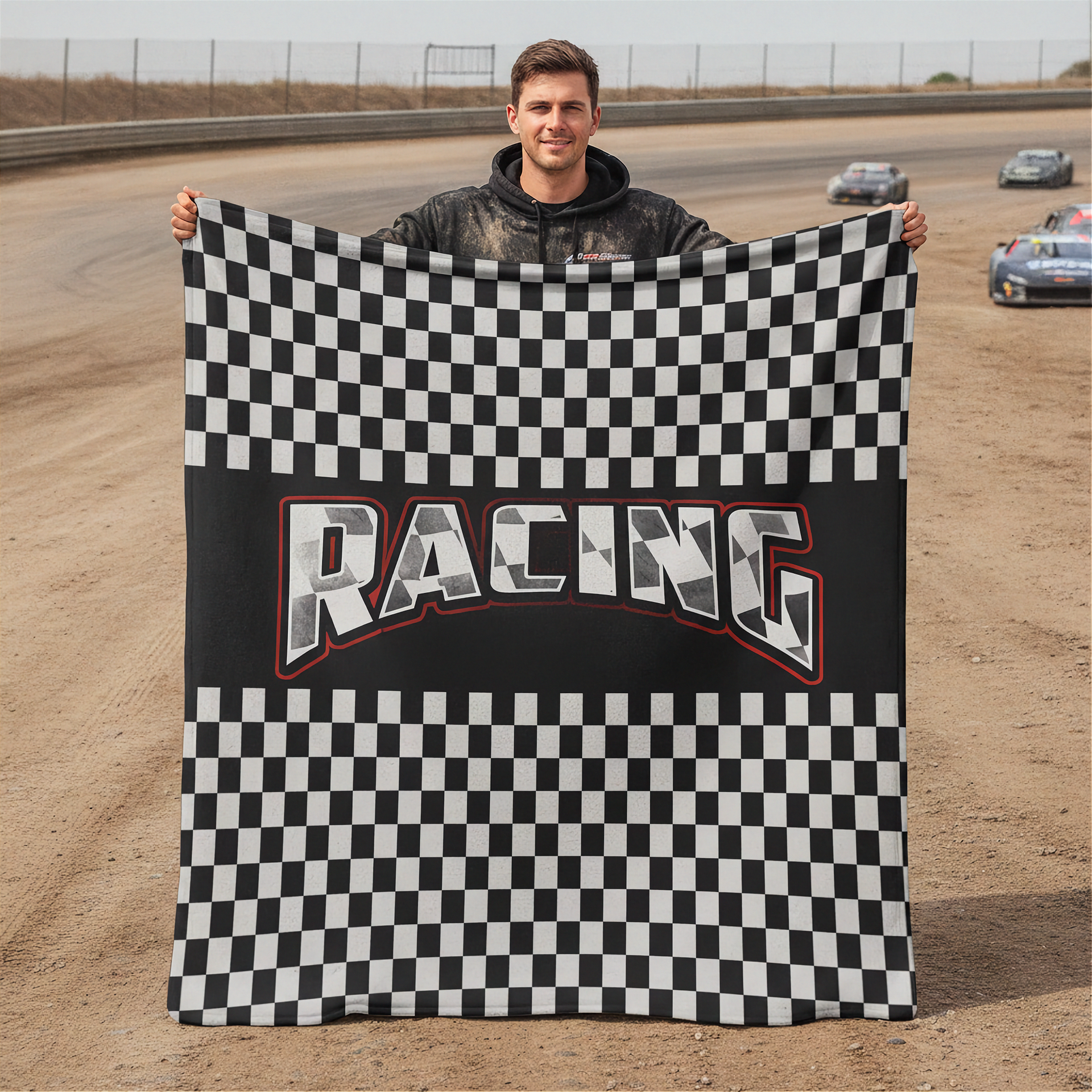 Man holding a checkered racing flag on a race track