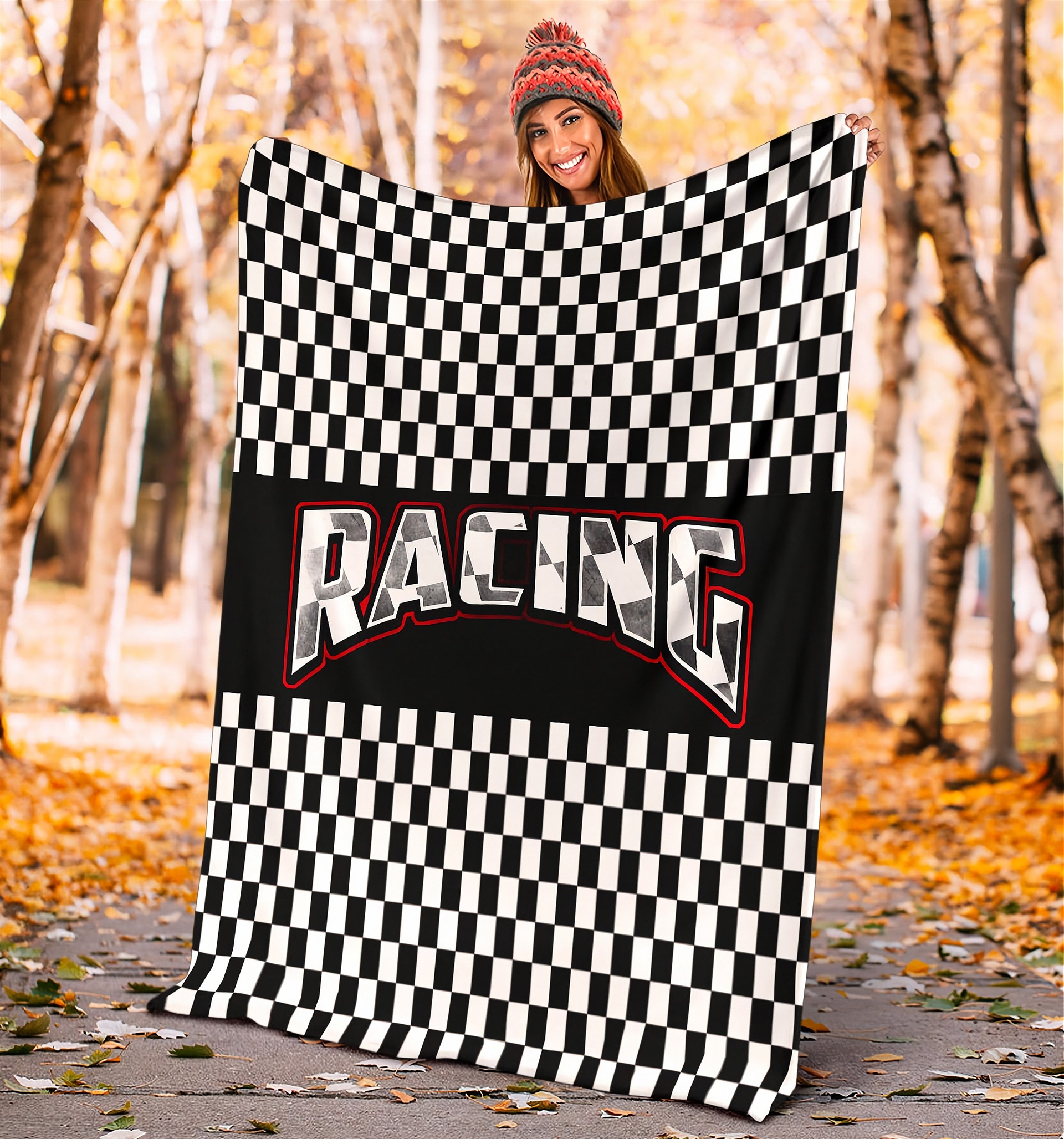 WOMAN holding a checkered racing blanket in an autumn setting