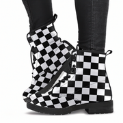 Black and white checkered boots worn with black pants on a white background