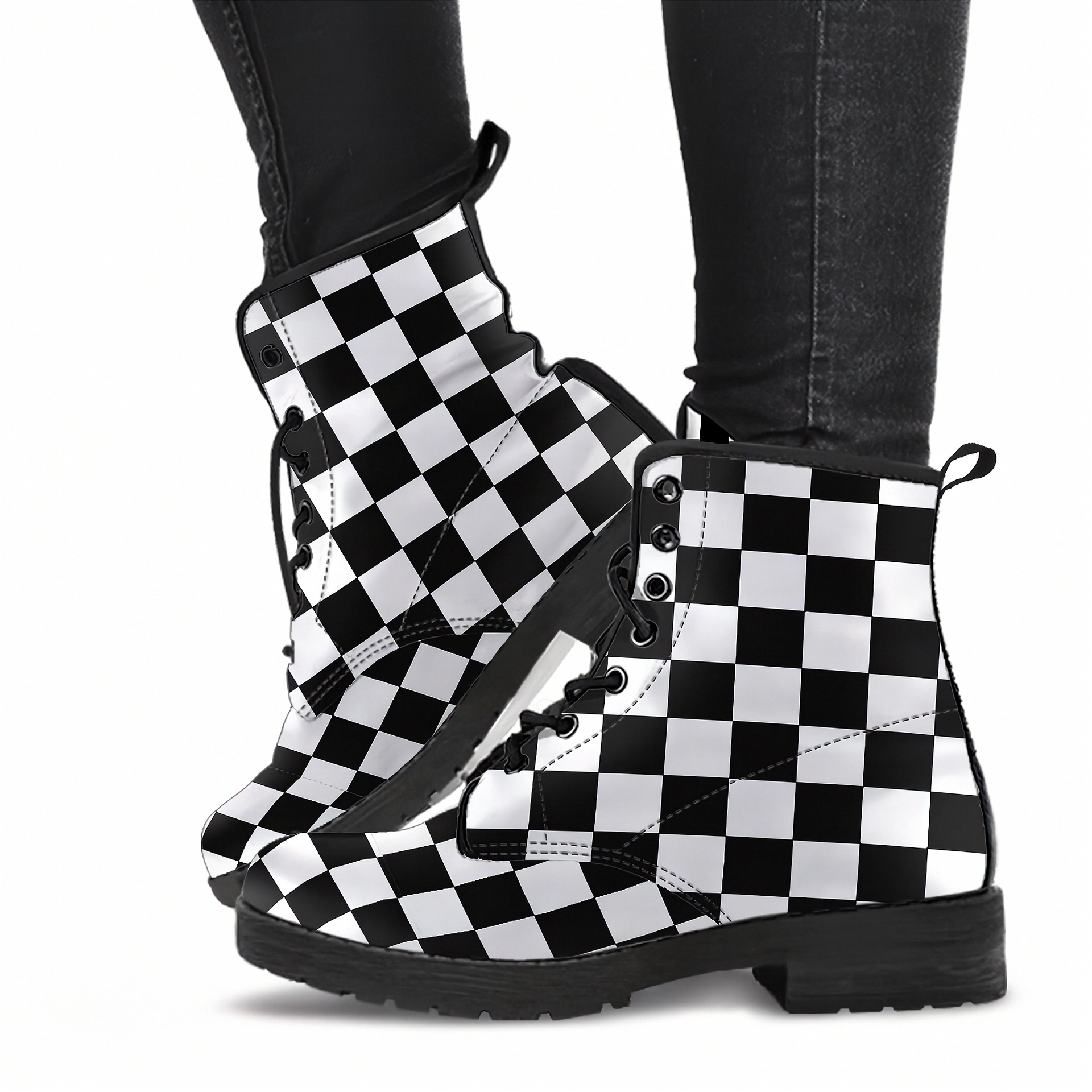 Black and white checkered boots worn with black pants on a white background