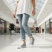 Woman wearing light blue jeans and checkered high-top sneakers in a mall setting