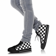 Person wearing black and white checkered high-top sneakers with light gray jeans on a white background