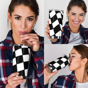 Woman holding a black and white checkered tumbler and smiling
