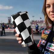 Woman holding a checkered pattern tumbler at a racing event