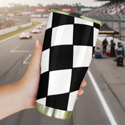 Checkered pattern tumbler held in front of a race track background
