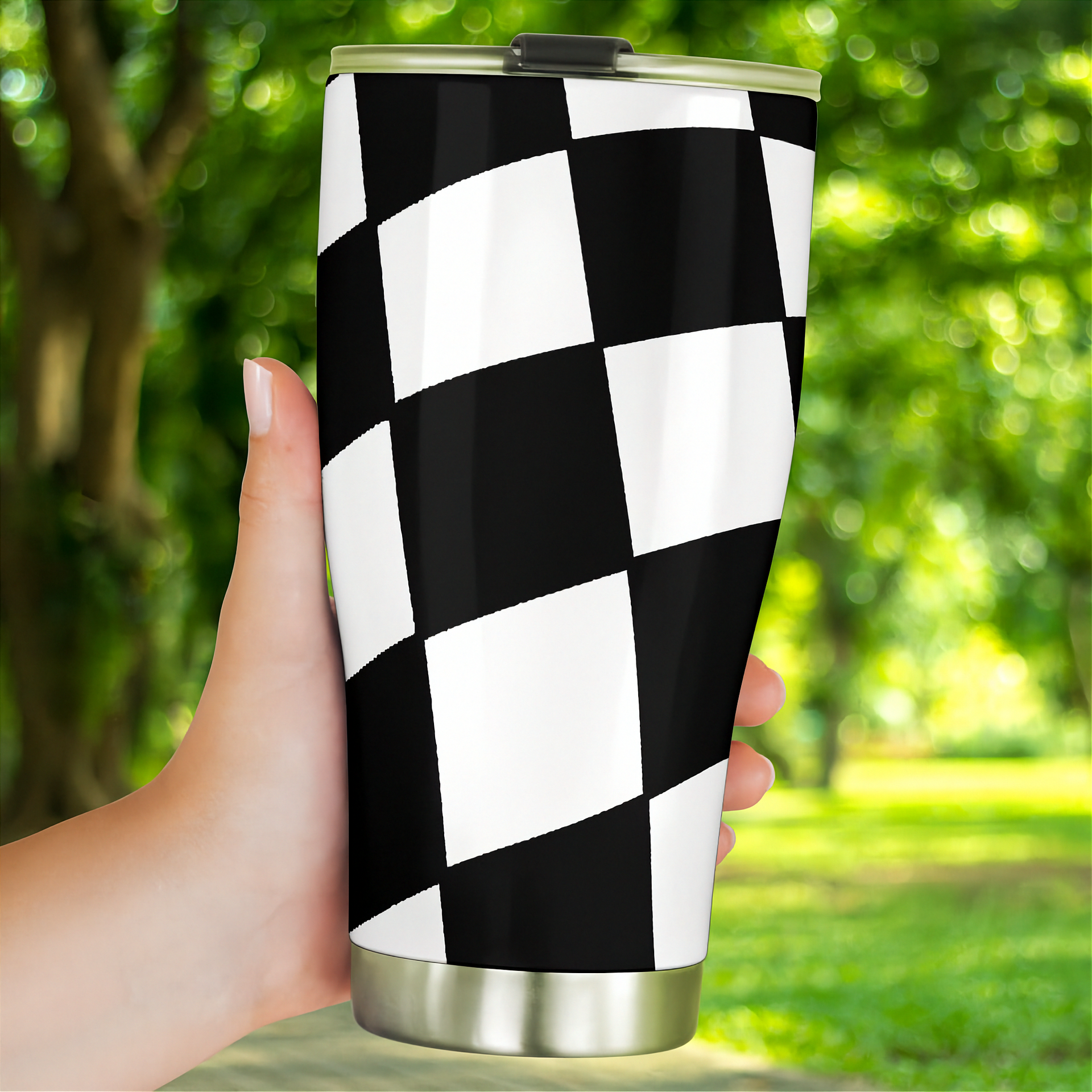 Woman holding a checkered tumbler
