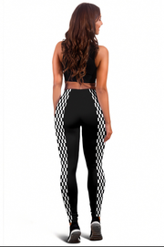 A woman shown from the back wearing black high-waisted leggings with a black and white checkered pattern down the sides, paired with a black sports bra, against a plain white background.