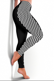 Black leggings with a 3D optical illusion checkerboard pattern on the upper thigh and calf, modeled on a person against a white background.