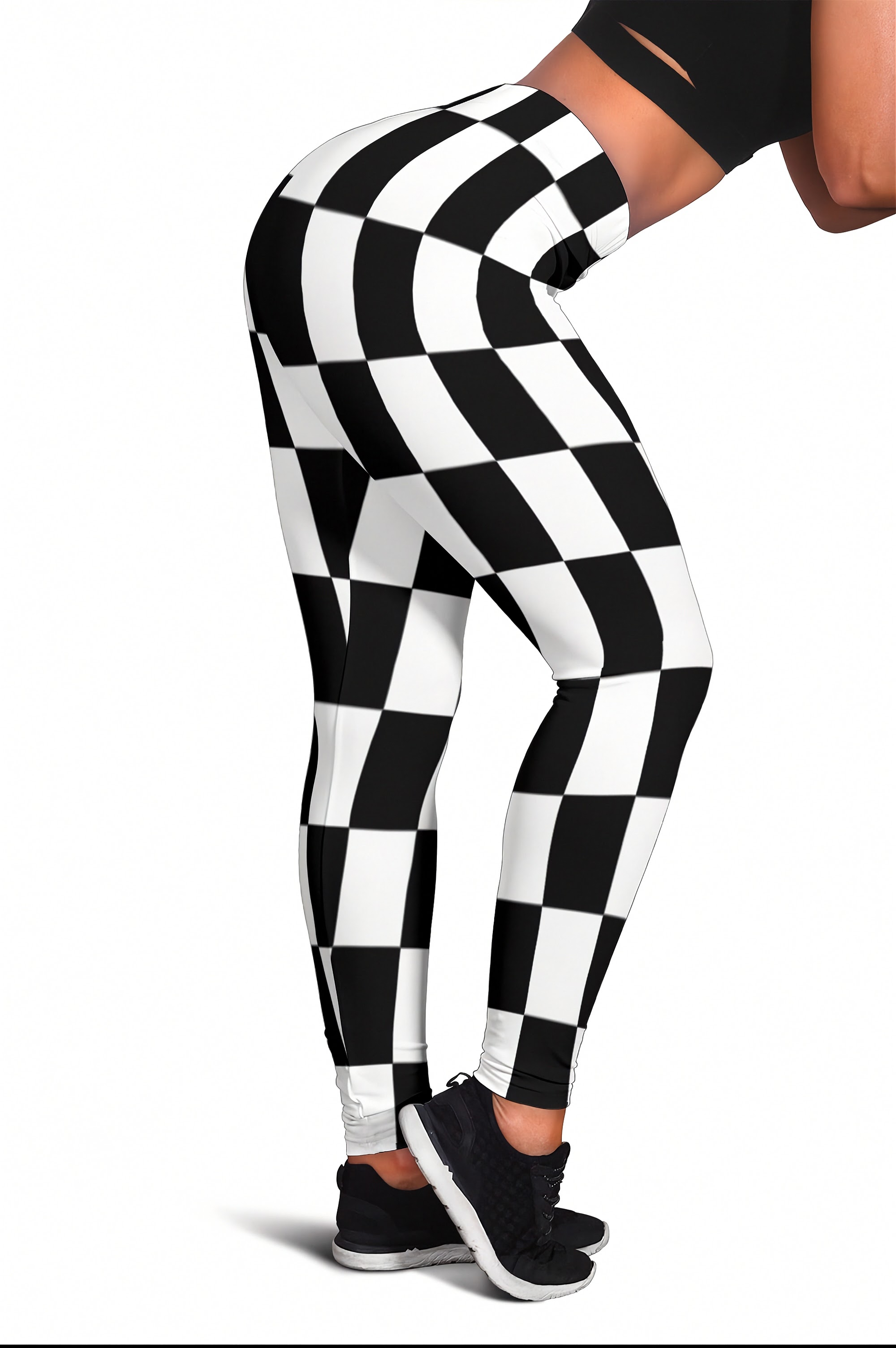 Black and white checkered pattern leggings shown on a model from a side-back angle, paired with black sneakers against a plain white background.