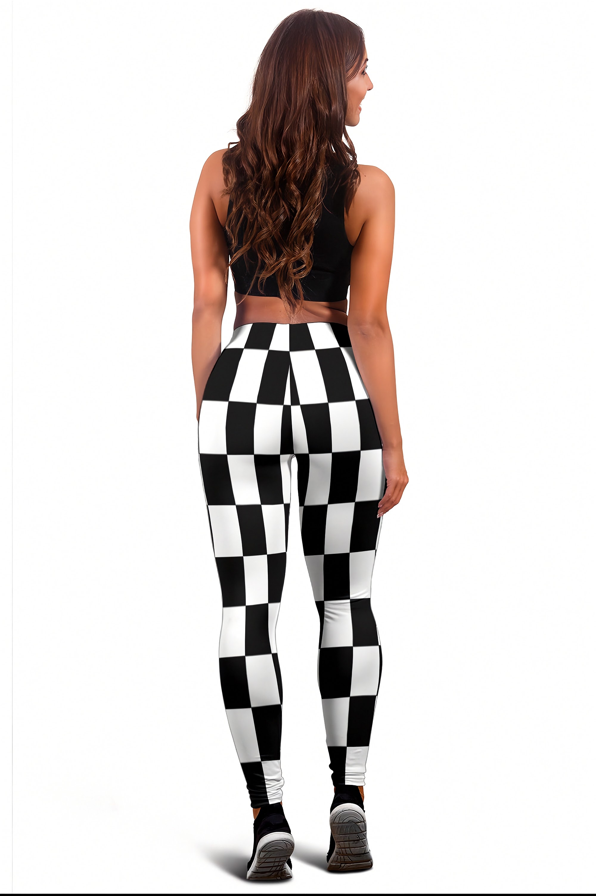 A woman shown from the back wearing black and white checkered high-waisted leggings, a black crop top, and black sneakers against a plain white background.