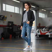 Woman standing in a garage with cars in the background
