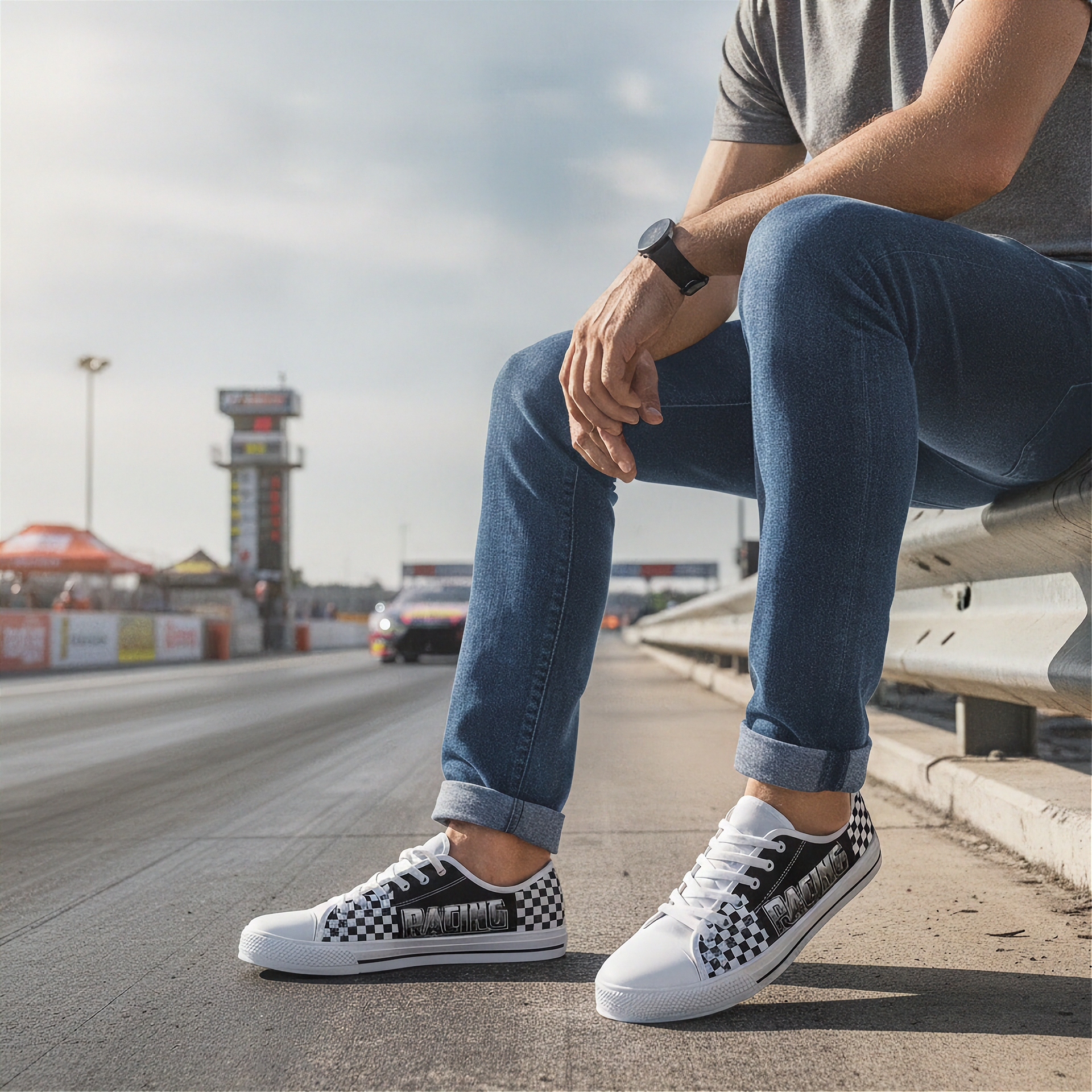 Person wearing checkered shoes sitting on a race track.