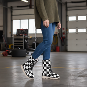 Person wearing black and white checkered boots in a garage setting