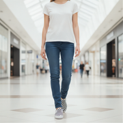 Person wearing a white t-shirt, blue jeans, and checkered shoes in a mall setting