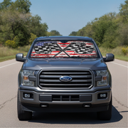 Ford truck on a road with a decorative sunshade featuring an American flag design.