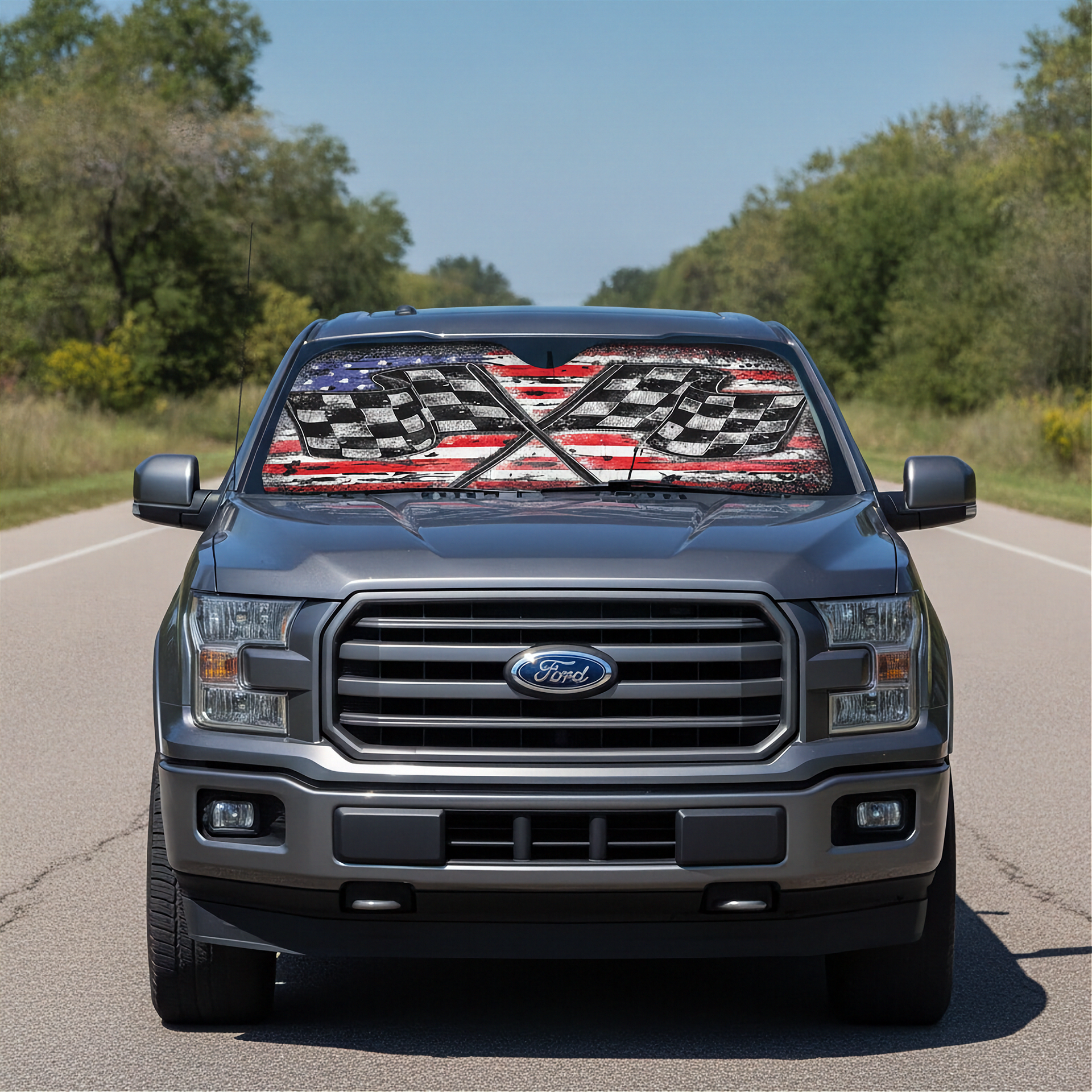 Ford truck on a road with a decorative sunshade featuring an American flag design.