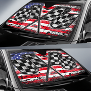 Car sunshades with American flag and checkered pattern on a vehicle.